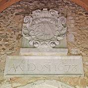 St Denis' church, East Hatley, Cambridgeshire – the newly cleaned Downing plaque, 13th April 2018. It's in the porch, above the door. Above the date is a cartouche of the arms of Sir George Downing, then owner of the estate of East Hatley.