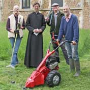 St Denis' church East Hatley, Cambridgeshire – blessing of the new mower. Under the churchyard management plan, the grass is allowed to grow very long – the Alco scythe (or scissor) mower makes cutting long grass relatively easy. Pictured left to right are Sarah Brennan, Reverend Steven Rothwell, John O'Sullivan, Peter Mann and Michael Pearson – 9-6-13. Photo: Philippa Pearson.