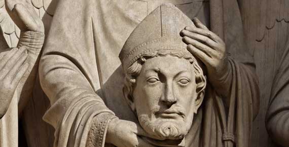 St Denis' statue in Notre-Dame Cathedral, Paris. He was beheaded around 250 AD - Notre-Dame was built on the site of his church 900 years later. A relic of St Denis, placed in the weather vane atop the cathedral's spire in the 1830s was lost in the devastating fire of 15th April 2019. [Photo by Thesupermat-CC BY-SA 3.0, https://commons.wikimedia.org/w/index.php?curid=21763309]