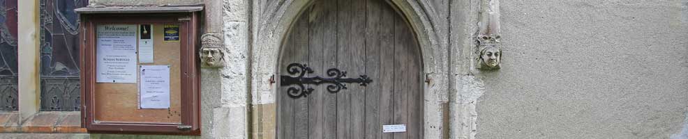 South door, notice board and two heads, Hatley St George church,-Hatley St George, Cambridgeshre – 13-9-18.