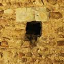 A putlog in the north wall of St Denis' church, East Hatley, put there when the church was built in the 13th century to secure wooden scaffolding; the stone cap is probably a later addition. It is one of several revealed when the old plaster was stripped off. Four have been left uncovered as visual historical features, two each on the south and north walls. Photo: Peter Mann / Buzz Associates.